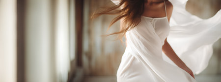 A woman in a flowing white dress dancing in a roomの素材