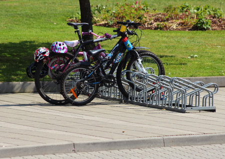 Two small and one adult bike with helmets places in tripodのeditorial素材