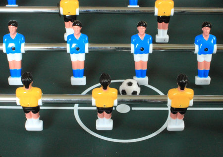 Football table game with blue and yellow players