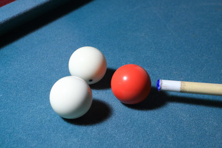 Carambole balls and cue near rail