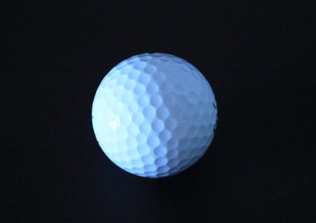 Golf ball close up with black backgoundの写真素材
