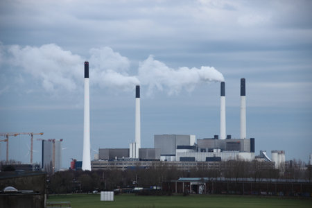 Factory chimneys at energy plant on a cloudy dayのeditorial素材