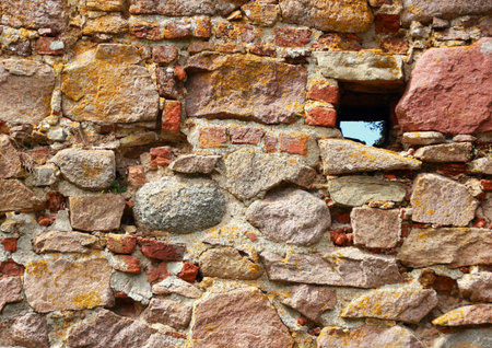Ancient ruin wall of rocks with holeの写真素材