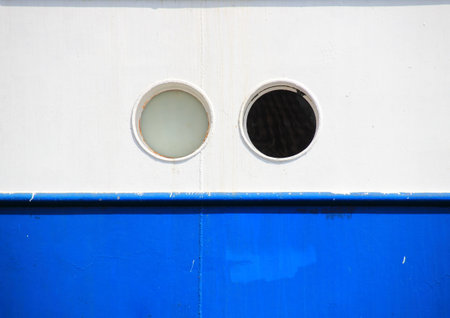 Two portholes on blue and white coaster backgroundの写真素材
