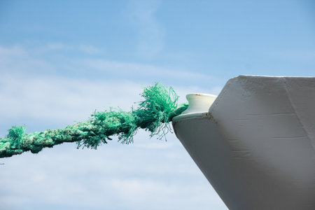 Green worn anchor rope on ship bowの写真素材