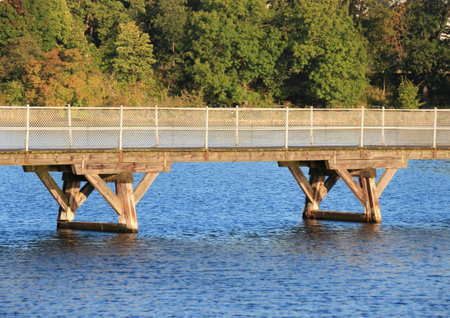 Low bridge over blue water with forest in backgroundのeditorial素材
