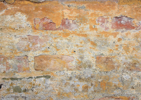Old weathered yellow brickwall texture and backgroundの写真素材