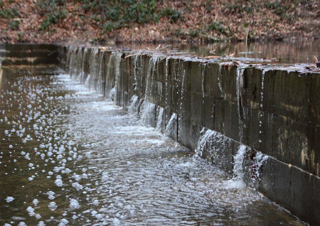 Embankment under Water Pressure after heavy Rainfall and filling up small water bedの写真素材