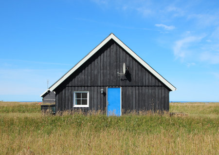 Summer House with Black Wood Planks and Center Blue Doorの写真素材