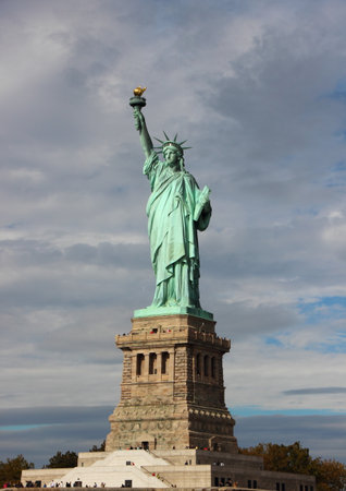 Statue of Liberty with Dark Blue Clouds Vertical Front viewの写真素材