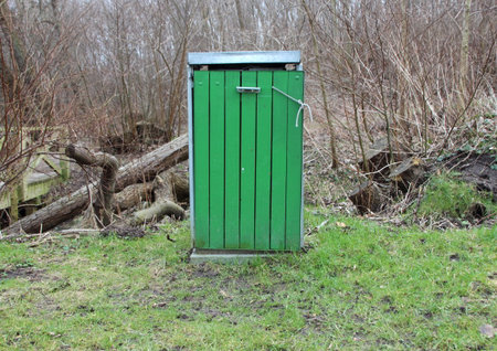 Wooden Green Isolated Garbage Bin in Forest with Metal Lidの写真素材