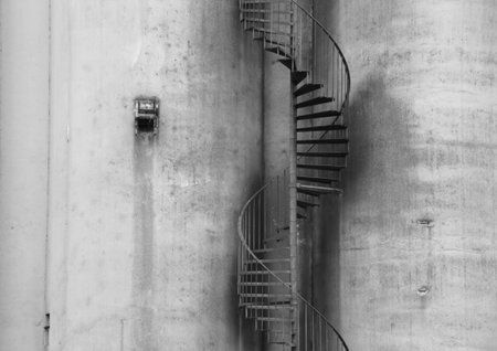 Abstract Closeup of Outdoor Metal Staircase on Concrete Grey Wallの写真素材