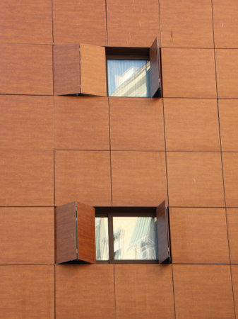 Modern Wooden Facade with Folded Window Shuttersの写真素材