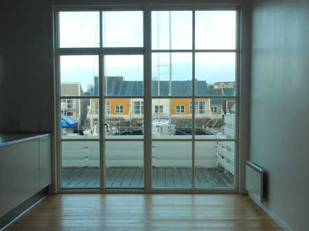 Empty Apartment Room with View to Harbor Houses and Balconyの写真素材