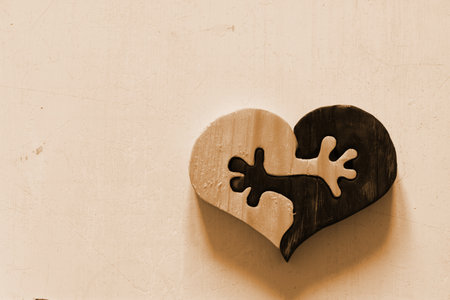 wooden heart ying yang hands sepiaの写真素材