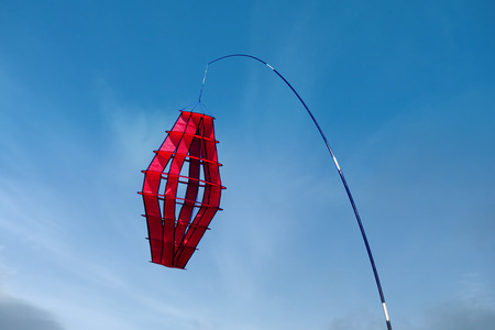 colorful kite flying in the blue skyの写真素材