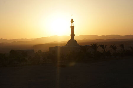 sunset over mosque in egypt town of el quesirの写真素材