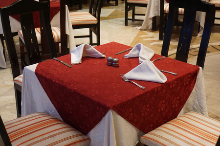 rustic restaurant tables and chairs for dinnerの写真素材