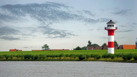 lighthouse on seawall at german river elbe near hamburg