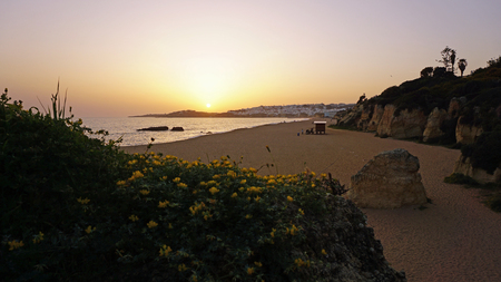 dusk on albufeira beach in portugalの写真素材