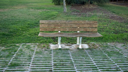 lisbon river side with a rustic park bench