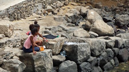 santa maria, cape verde, circa june 2018: young girls playing at the coastのeditorial素材
