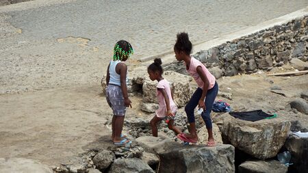 santa maria, cape verde, circa june 2018: young girls playing at the coastのeditorial素材