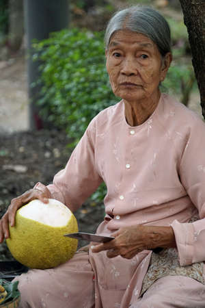 hue, vietnam, circa january 2020: locals sellings their products on a market