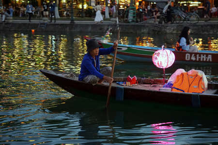 hoi an, vietnam, circa february 2020: boat driver on the riverのeditorial素材