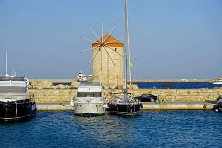 famous windmills at madraki harbor of rhodesの写真素材