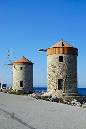 traditional windmill at mandraki harbor of rhodes in greeceの写真素材