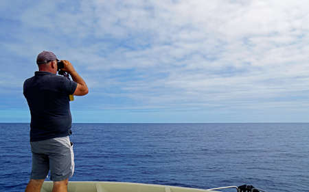 sao miguel, azores, portugal, circa september 2021 - whale watcher looking for whales in the ocean