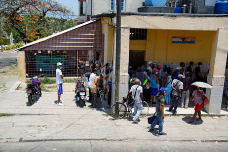 Havana, Cuba, circa May 2022: Food Shortage - Locals waiting at a shop to buy some food