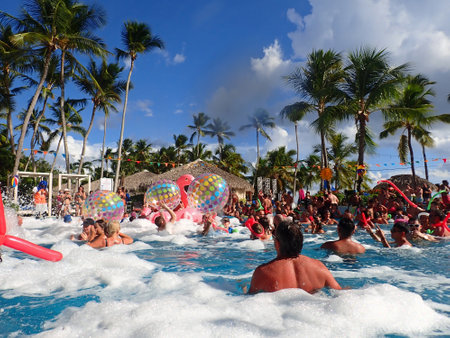 Bayahibe, Dominican Republic, circa September 2022 - Young people enjoying pool party with foam in a hotelのeditorial素材