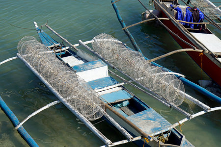 traditional small wooden outrigger boats at a fisherman villageの写真素材