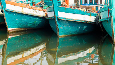 colorful wooden fishing boats in a harbor in kampot in cambodiaの写真素材