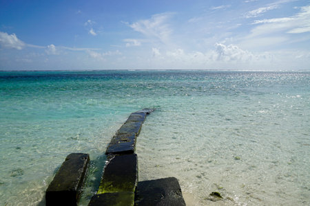 Jetty at Sunny tropical beach paradise on the Maldives islandsの写真素材