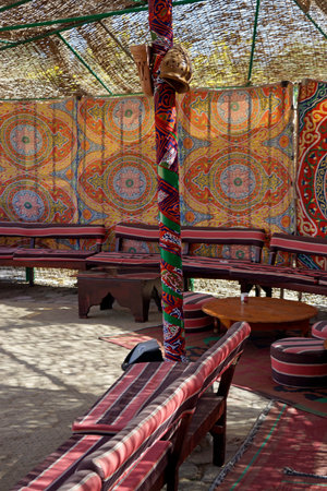 Traditional seating area with a colorful patterned Bedouin carpetの写真素材