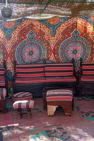 Traditional seating area with a colorful patterned Bedouin carpet