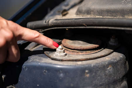 A woman shows a rusty strut bearing.