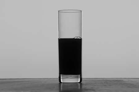 Glass with juice - black and white photo of an objectの写真素材