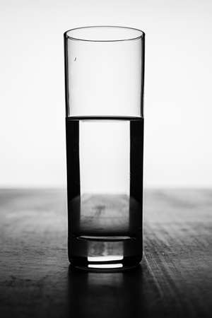 Glass with water - black and white photoの写真素材