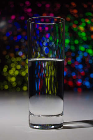 Glass with water with bokeh - object with bokeh backgroundの写真素材