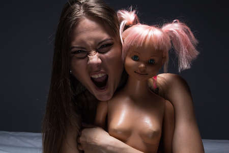 Woman holding a dollの写真素材