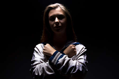 Serious teenager girl in shadow - photo portraitの写真素材