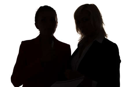 Two women looking at camera - silhouette on white backgroundの写真素材