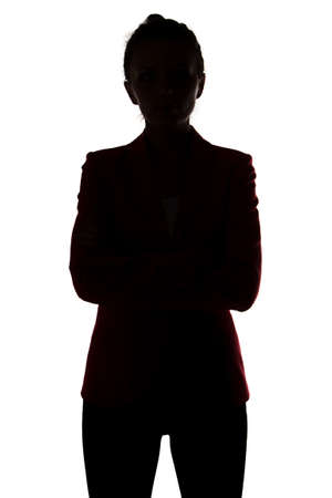Silhouette of businesswoman with arms crossed on white backgroundの写真素材