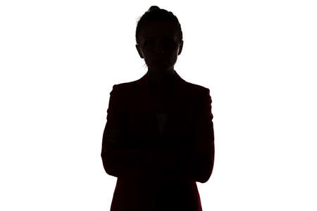 Silhouette of business woman with arms crossed on white backgroundの写真素材
