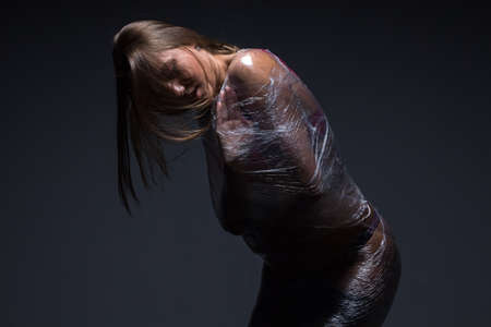 Photo of wraped girl on black backgroundの写真素材
