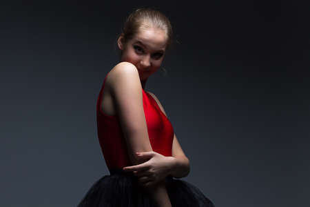 Photo of pretty young girl on dark backgroundの写真素材